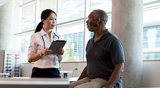 An older man talking to a medical professional about fibromyalgia.