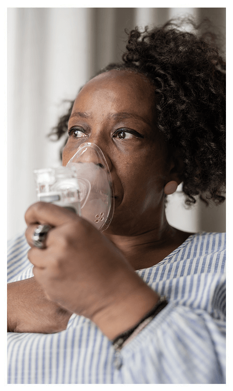 A woman using a respirator.